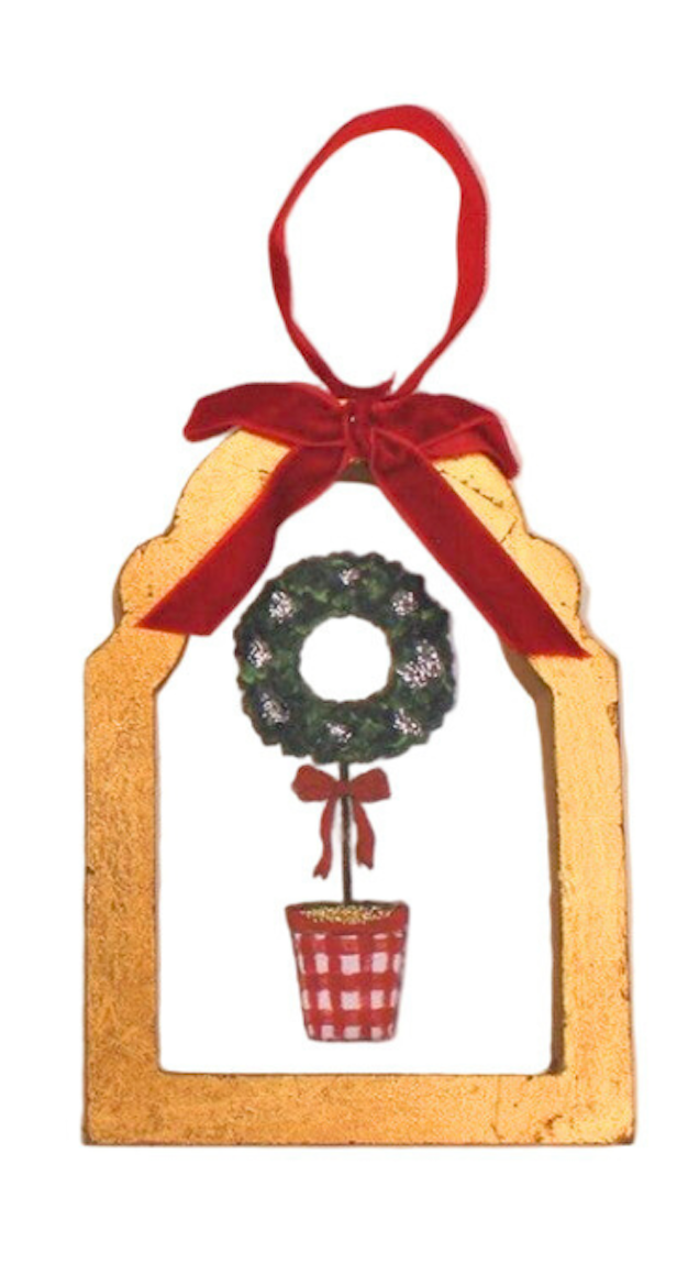 Decorative Christmas ornament with a wooden frame, wreath, and red ribbon on a white background.
