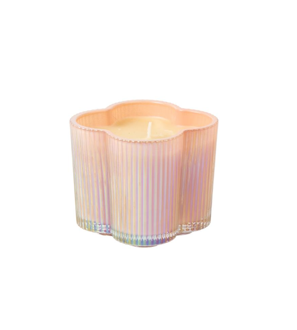 Decorative candle in a ribbed container on a white background