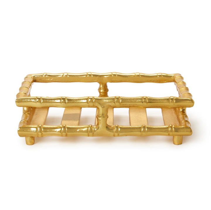 Gold bamboo-style trivet on a white background