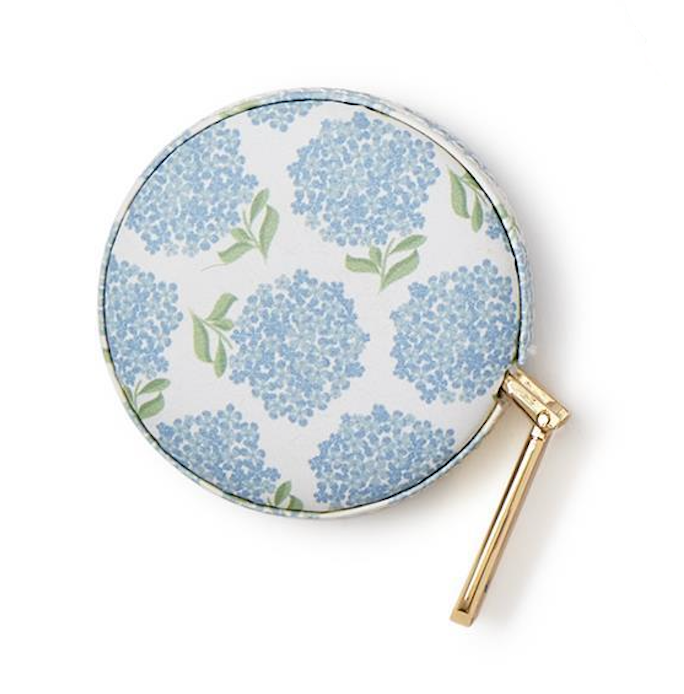Round hand mirror with blue floral pattern on a white background