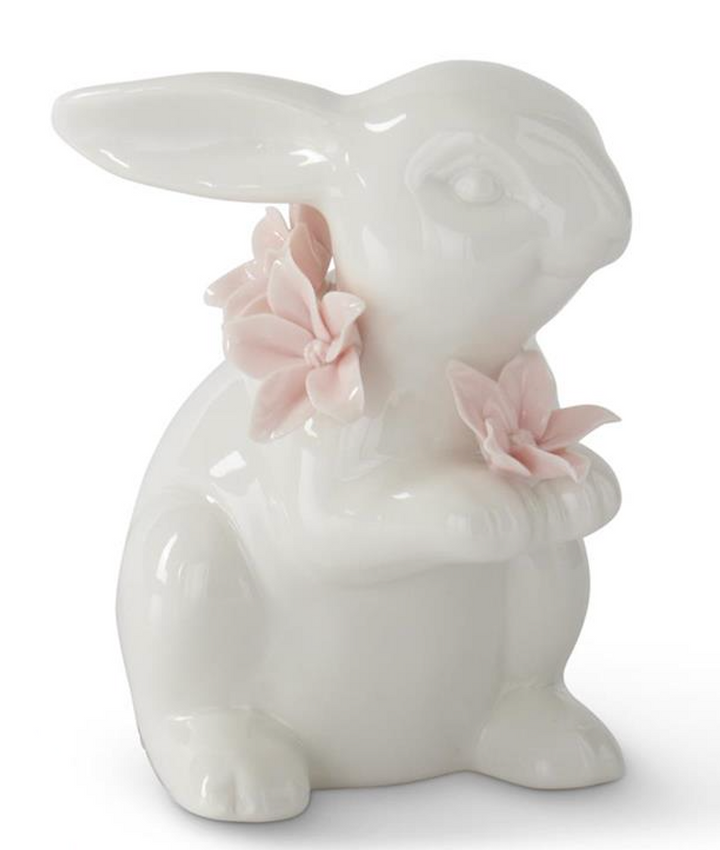 White ceramic bunny figurine with pink flowers on a white background
