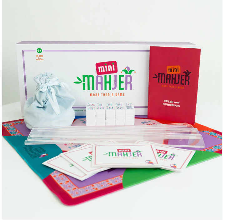 Mini Mahjer game set with colorful board, tiles, racks, scorecards, and rulebook on a white background. | Walker Boutique