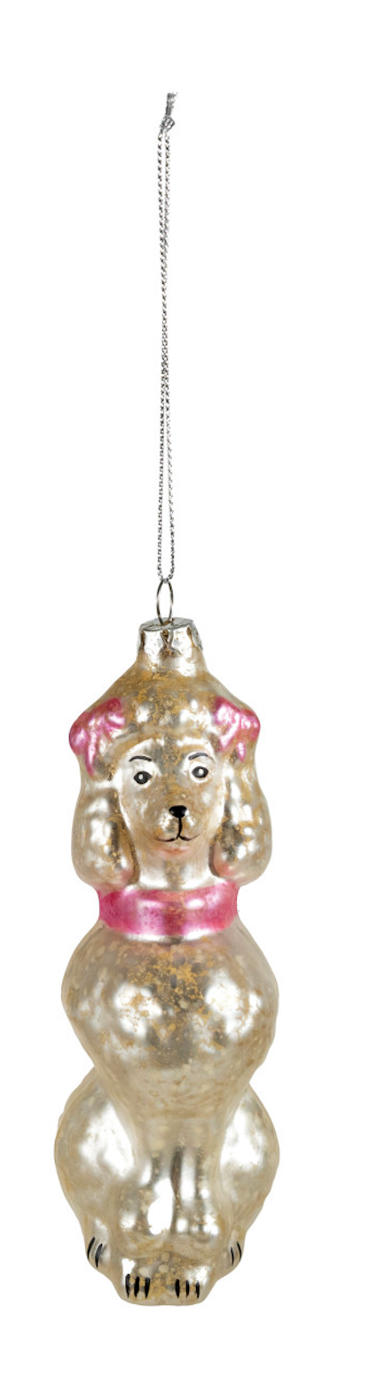 A vintage-style poodle Christmas ornament made of iridescent gold glass with pink fabric ears and a pink collar, hanging from a silver wire on a white background.