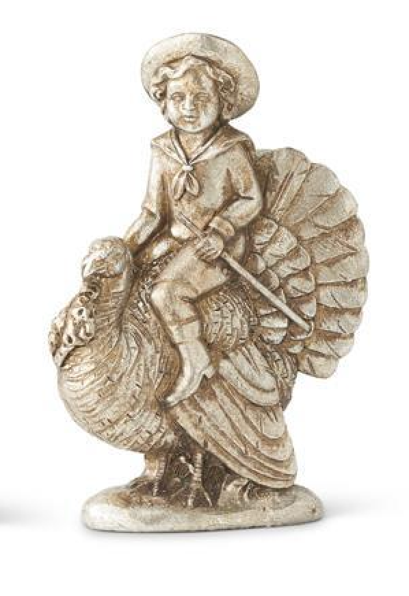 A small metallic figurine depicting a child riding a turkey, shown against a plain white background.