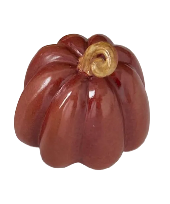A glossy ceramic decorative pumpkin figurine in a deep reddish-brown glaze with a small curled tan stem, shown on a white background.