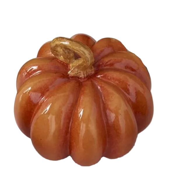 A glossy ceramic pumpkin figurine in shades of orange and brown, shown on a white background 