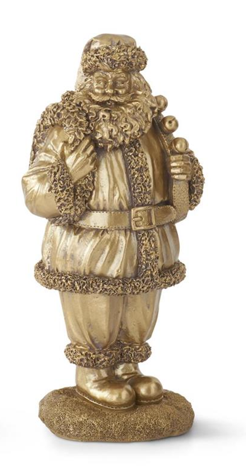 A metallic gold Santa Claus figurine standing on a textured base, holding a sack and a gift, photographed against a plain white background.