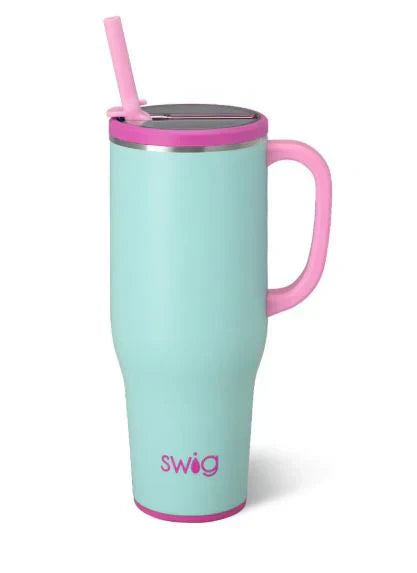 Turquoise mug with pink handle and straw on a white background