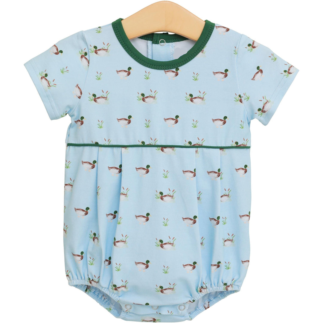 Baby romper with duck pattern on a hanger against a white background