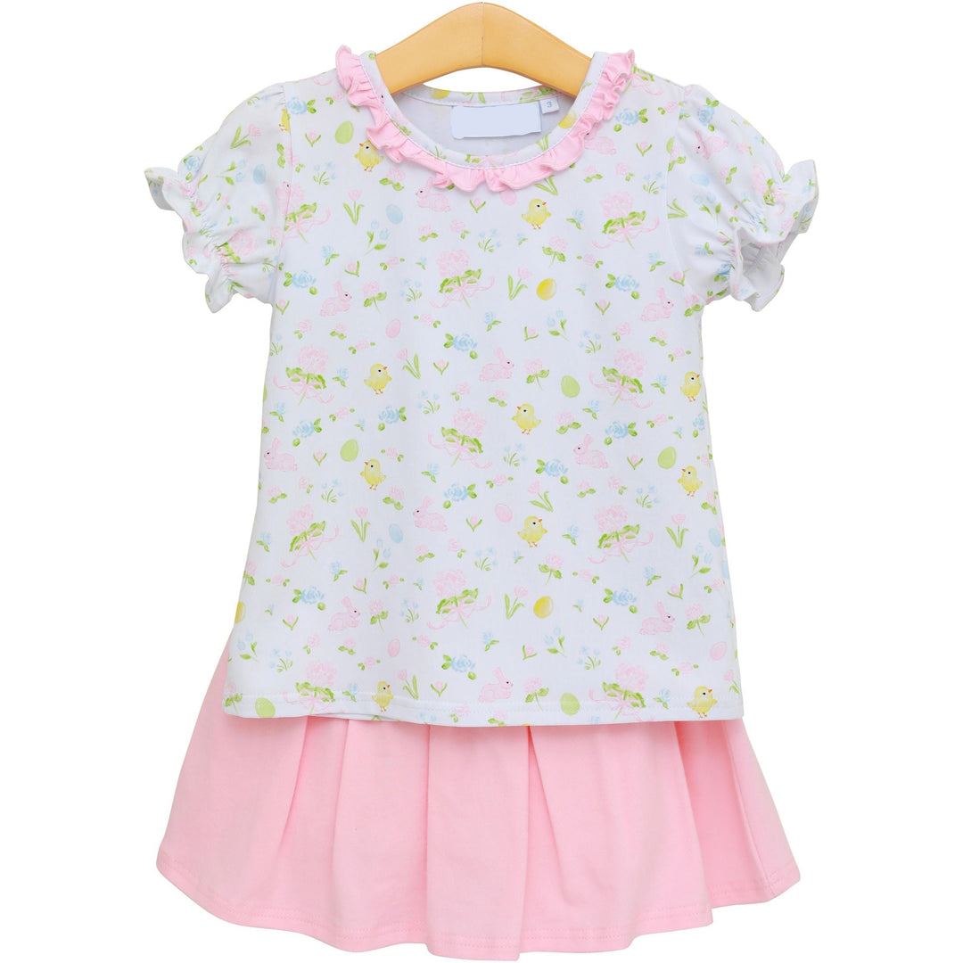 Children's dress with floral pattern and pink skirt on a hanger