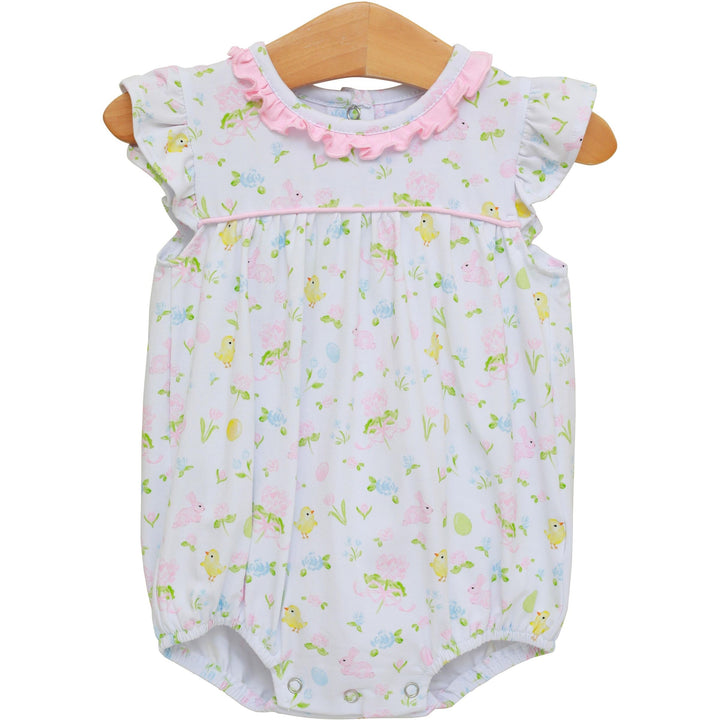 Baby romper with duck pattern on a wooden hanger against a white background