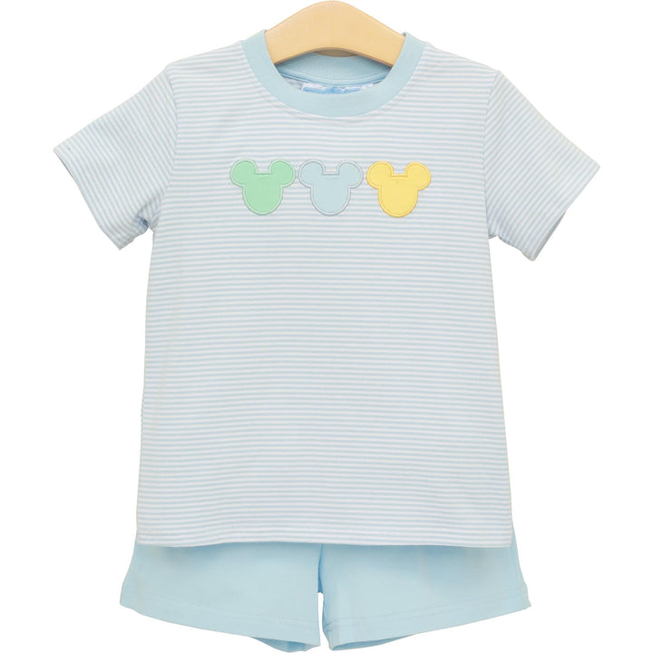 Children's outfit with striped shirt and shorts on a hanger against a white background