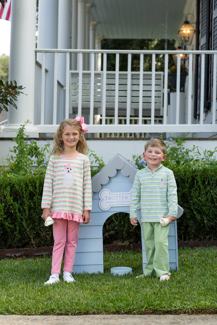 YOUNG GIRL AND LITTLE BOY IN COORDINATING OUTFITS IN FRONT OF BLUE DOG HOUSE
