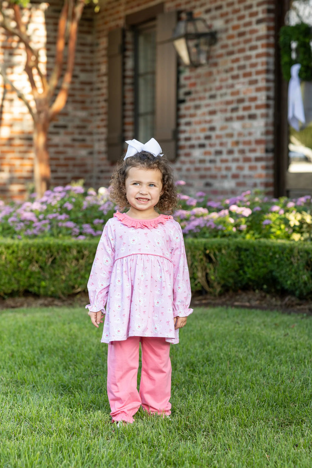 LITTLE GIRL IN GRASS WEARING TEA FOR TWO PRINT PINK BLOOMER PANT SET