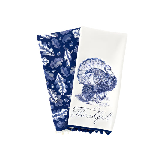 Two decorative towels with blue leaf pattern and turkey design on a white background