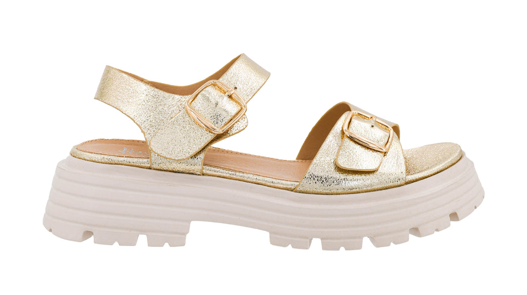 Gold platform sandal with a white sole on a white background