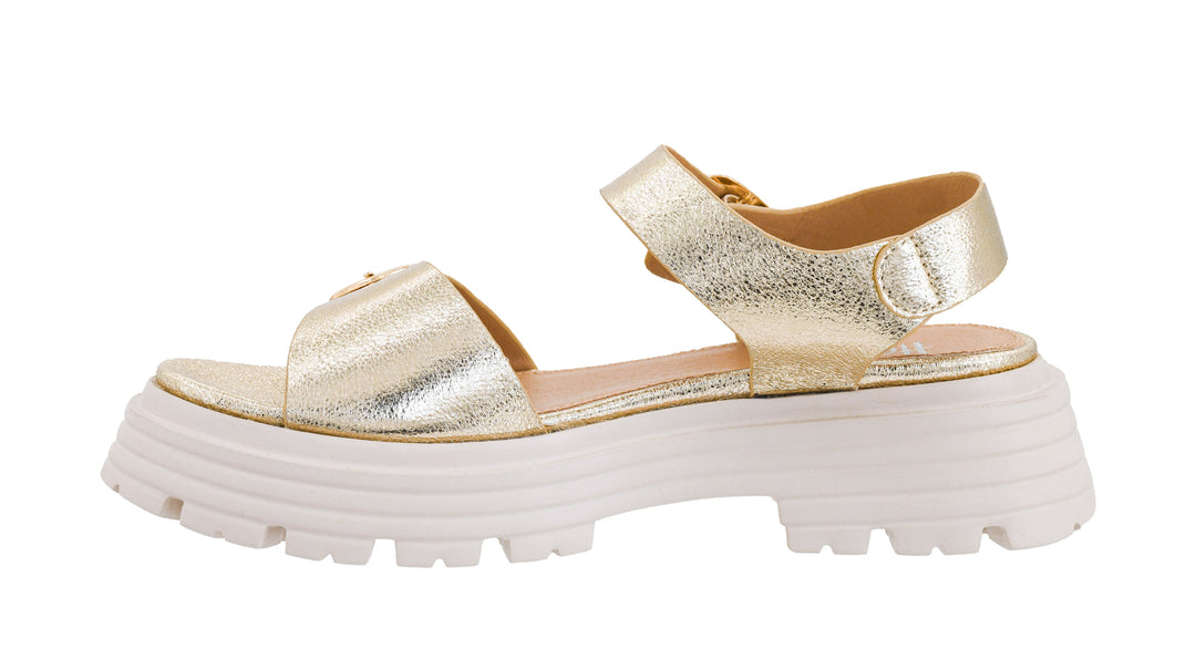 Gold glittery sandal with a thick white sole on a white background