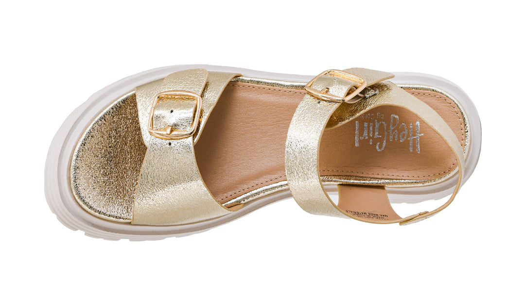 Gold sandal with a white sole on a white background