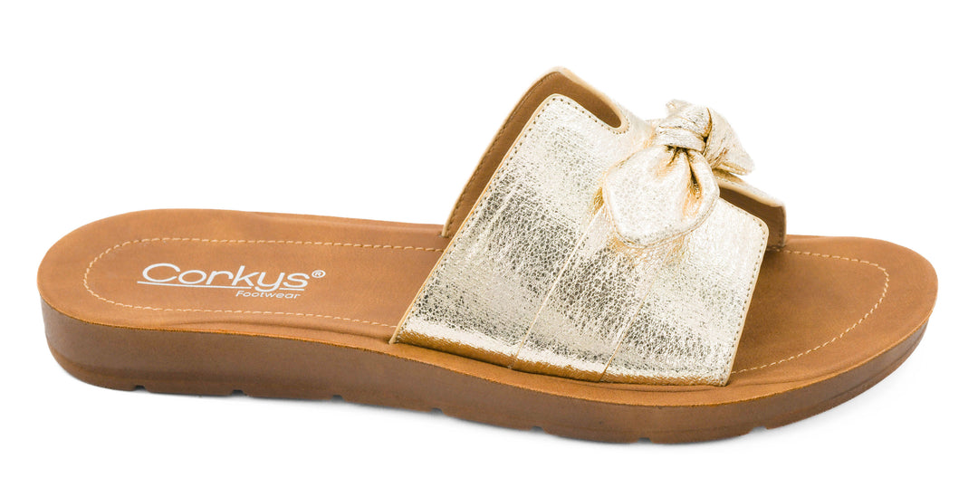 Gold sandal with a bow on a white background