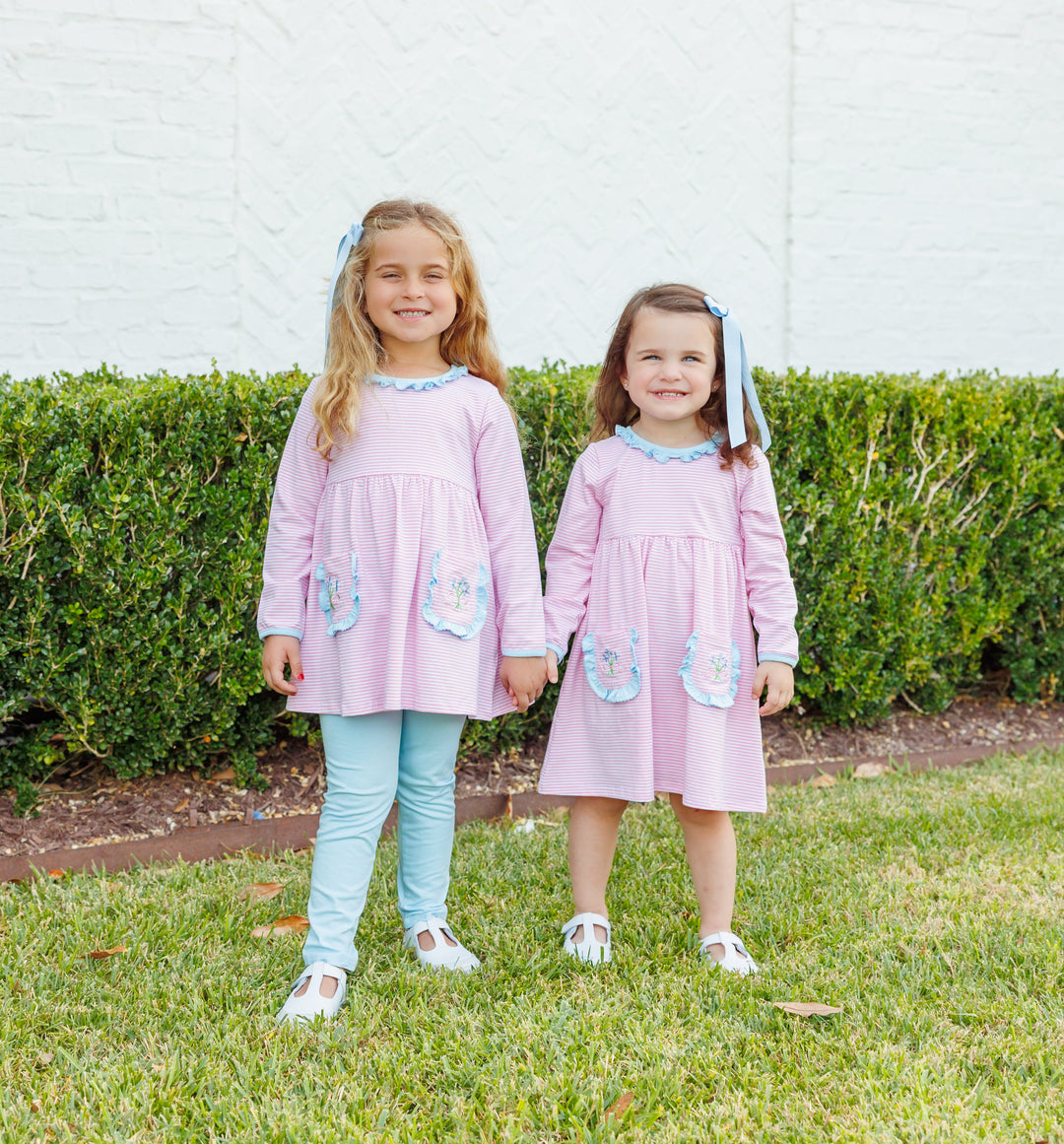 TWO LITTLE GIRLS WEARING COORDINATING SWEET FLOWER BOUQUET PINK STRIPED DRESS AND PANT SET IN GRASS