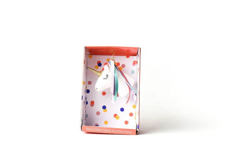 Unicorn figurine ornament in a polka dot gift box on a white background
