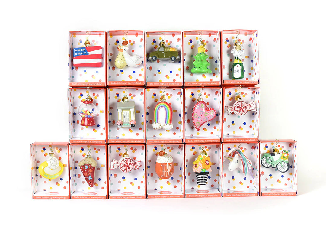 Set of small decorative items in individually wrapped boxes on a white background