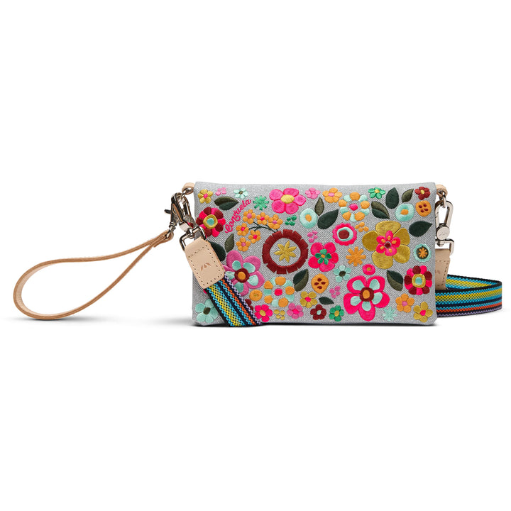 Floral patterned handbag with a strap on a white background