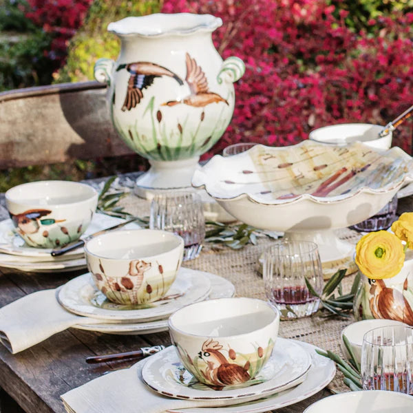 Decorative table setting with animal-themed ceramic items outdoors.