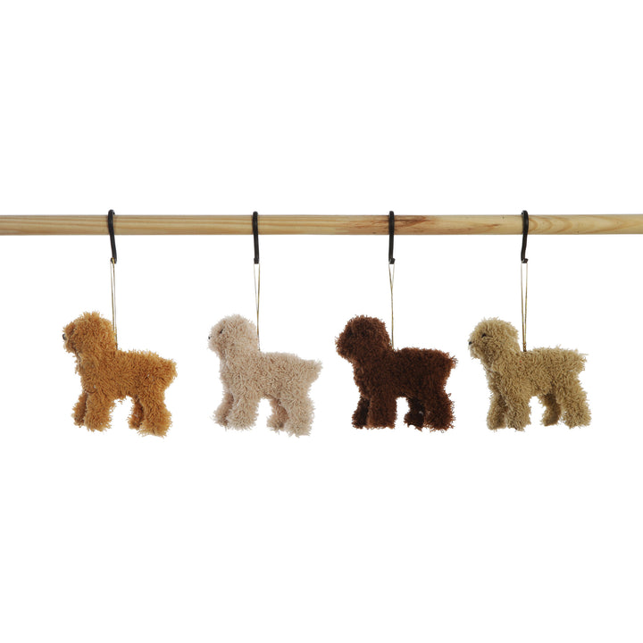 Four fluffy dog-shaped hanging ornaments in tan, cream, dark brown, and light beige, suspended from a wooden rod against a white background.