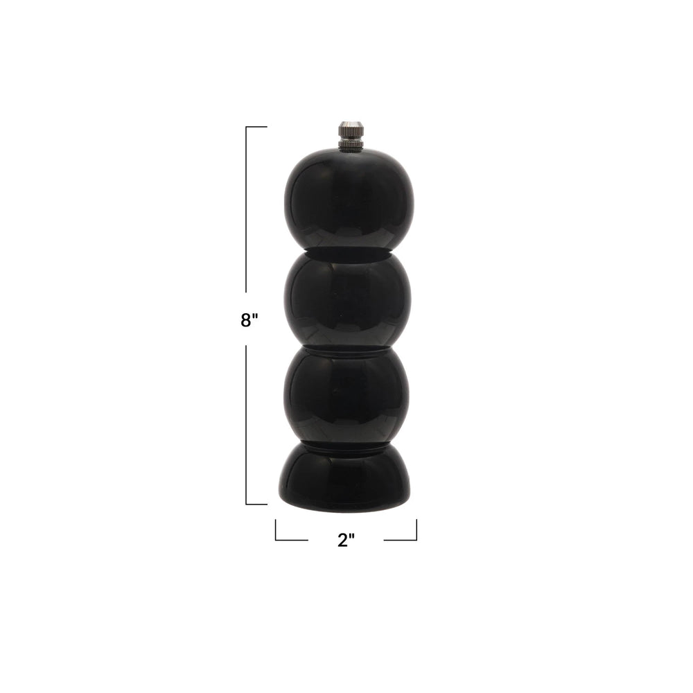 Black pepper grinder with measurements on a white background
