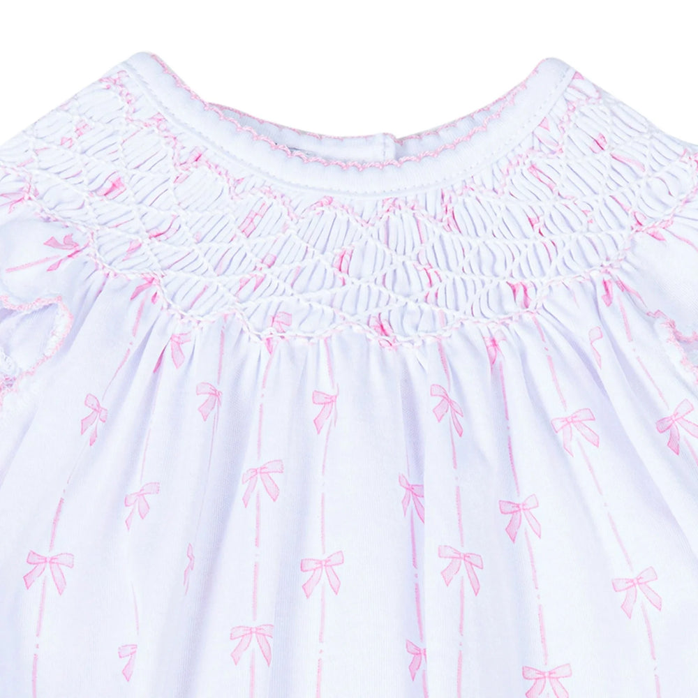 White smocking with pink bow pattern on a white background