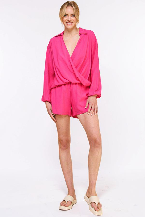 Woman wearing a bright pink outfit on a white background