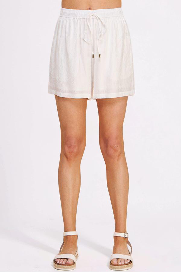 White shorts worn by a person on a white background