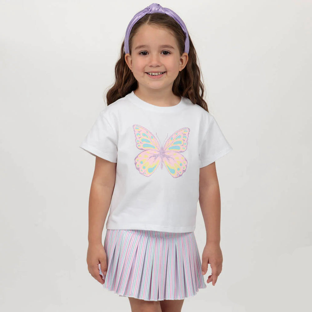 Young girl wearing a white t-shirt with a butterfly design and a striped skirt on a plain background.