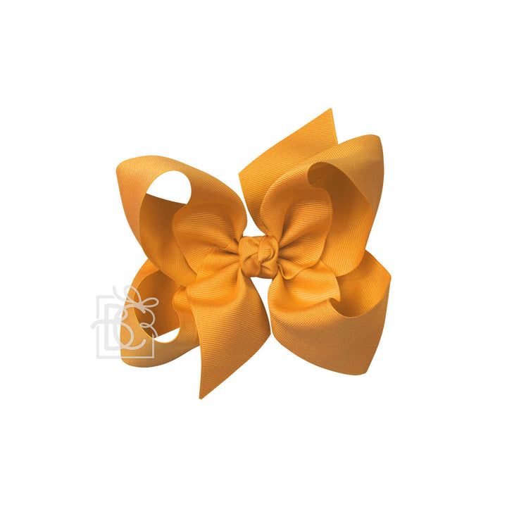 Yellow hair bow on a white background