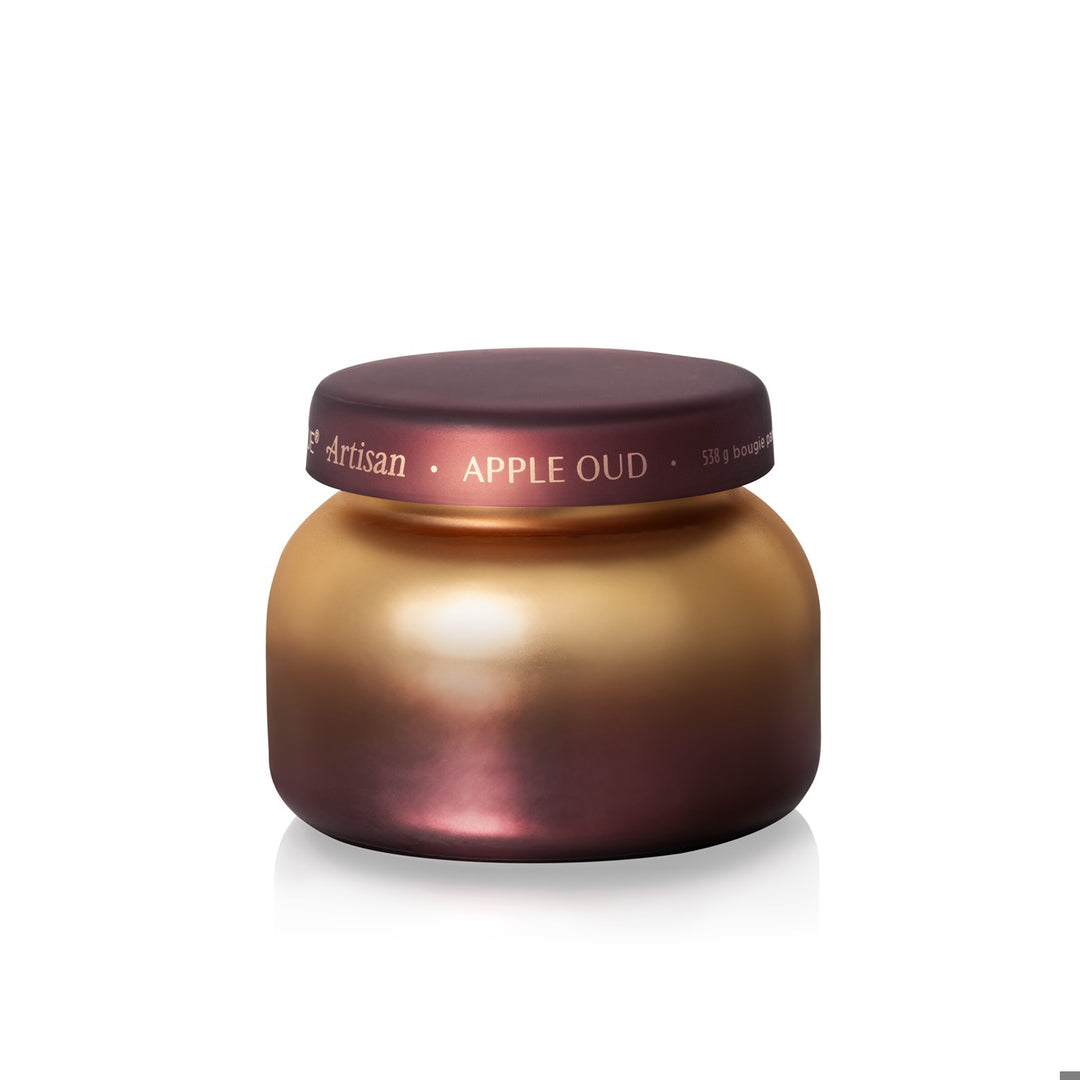 Apple Oud Tuscan Radiance signature candle in a gold and burgundy ombre glass jar