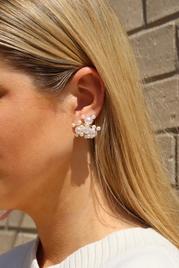 Alana pearl cluster statement earring worn on the ear for a bold feminine look