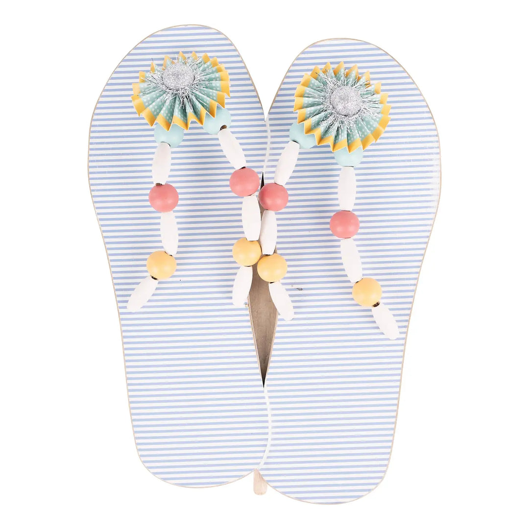 Blue striped flip-flop wall décor with pastel beaded straps and decorative rosette accents. | Walker Boutique