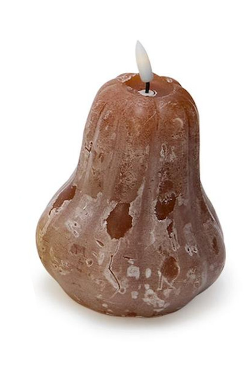 Pear-shaped candle with a lit wick on a white background