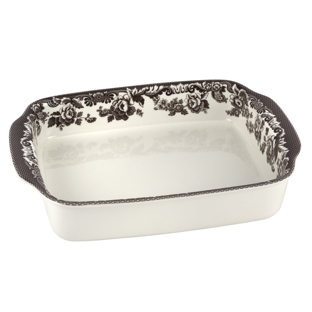 A rectangular fine porcelain lasagne dish with black floral patterns on the sides.