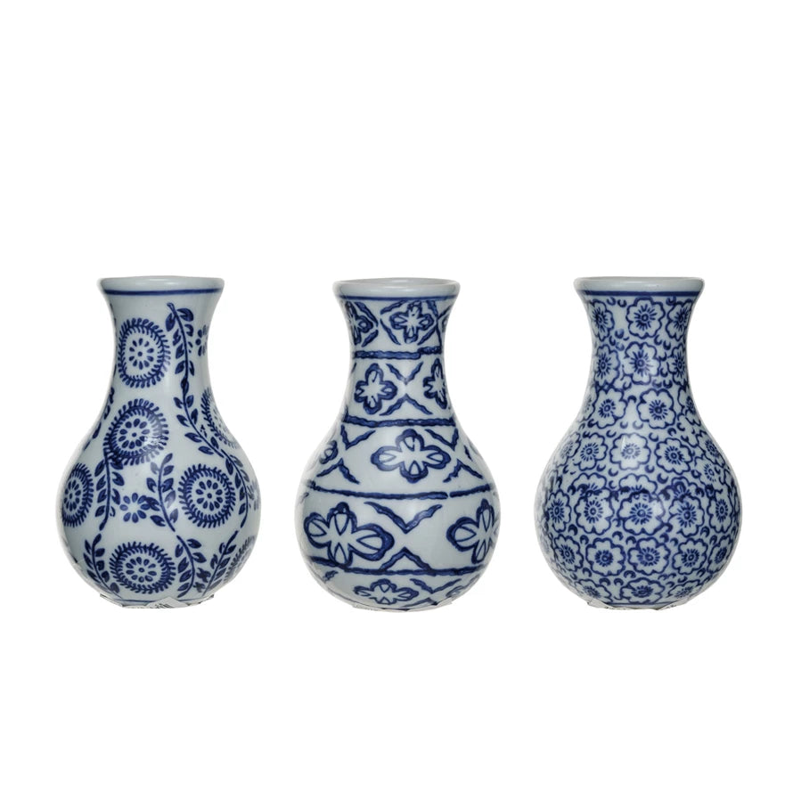 Three blue and white patterned vases on a white background