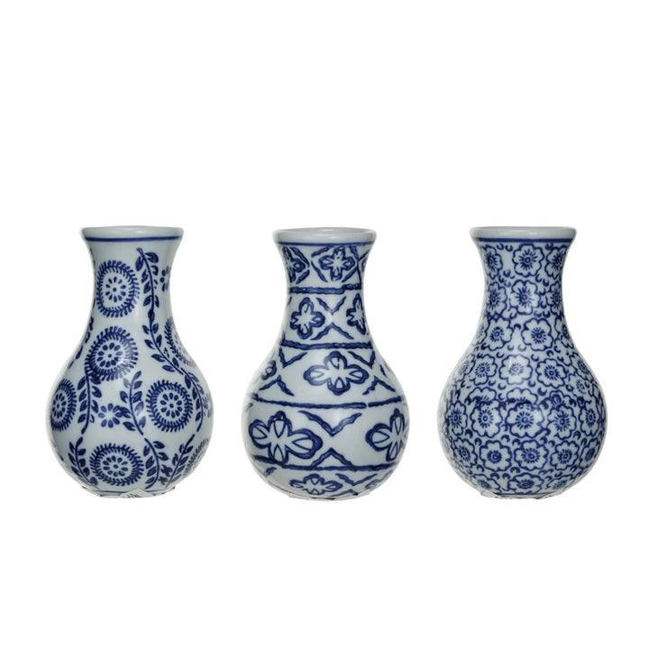 Three blue and white patterned vases on a white background