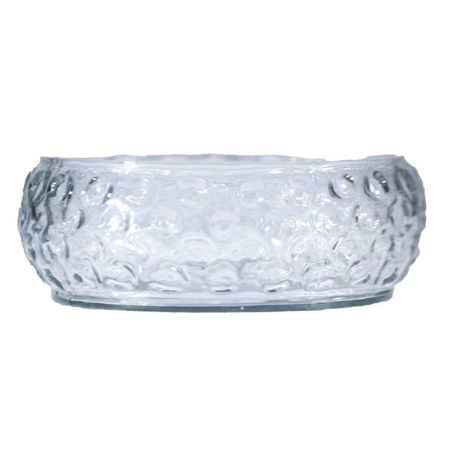 Clear glass bowl with textured surface on a white background