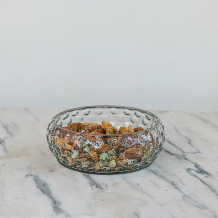 Glass bowl with pet treats on a marble surface