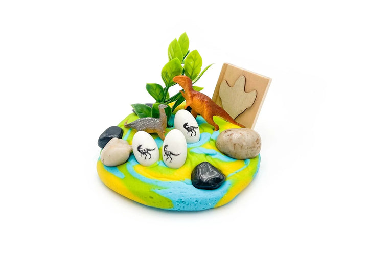 Miniature diorama with dinosaur eggs, a dinosaur figure, and a wooden sign on a white background