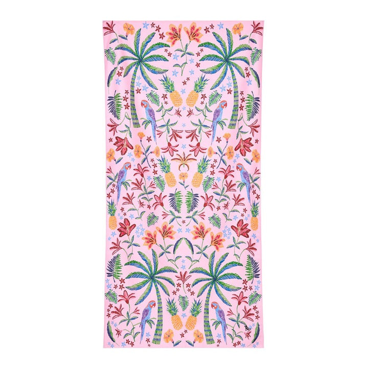 Tropical patterned towel with palm trees, flowers, and parrots on a pink background