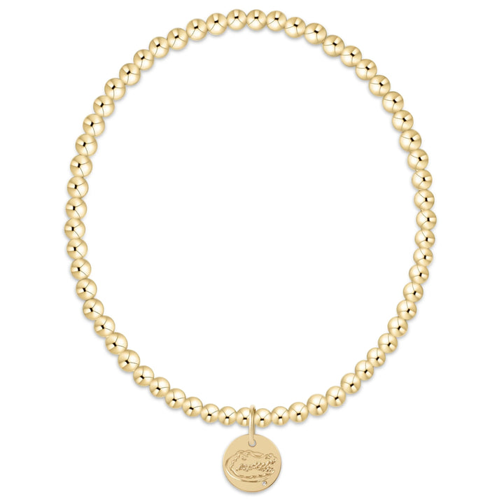 Gold beaded bracelet with a round disc with University of Florida Gators on a white background