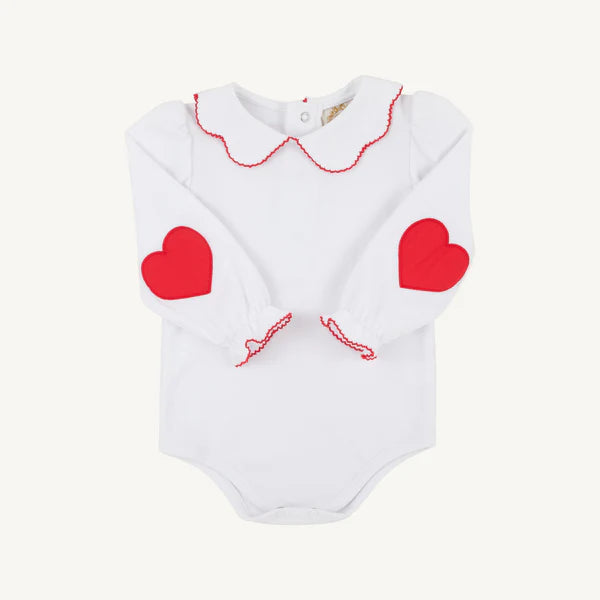White baby romper with red heart designs on a white background