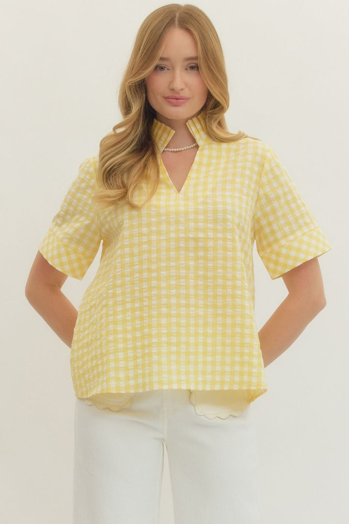 SHEER YELLOW GINGHAM SHORTSLEEVE BLOUSE ON WHITE BACKGROUND