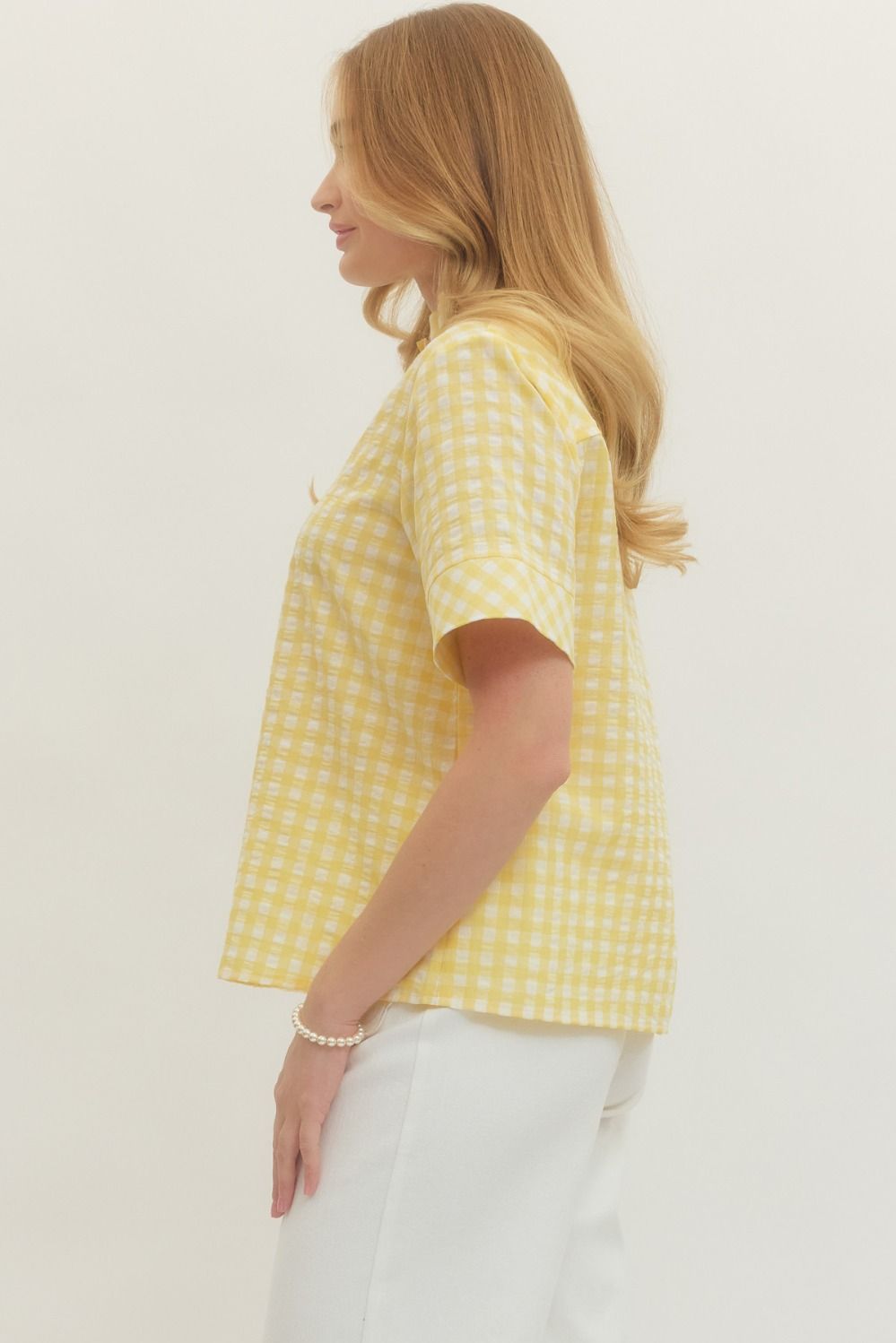 SIDE VIEW OF SHEER YELLOW GINGHAM SHORTSLEEVE BLOUSE ON WHITE BACKGROUND